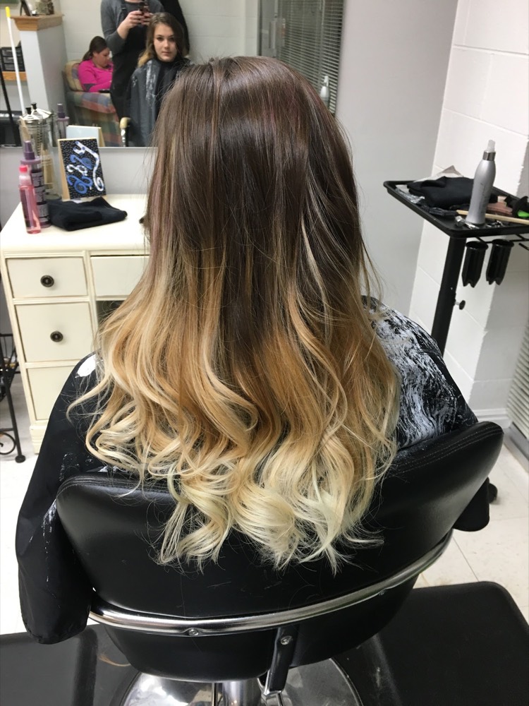 Dark-to-blonde ombre balayage in the salon chair